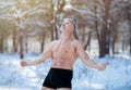 Senior man standing in underpants, showing thumbs up gesture, recommending cold resistance training at winter park Royalty Free Stock Photo