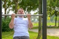 Senior man straining to lift himself up by the arms