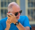 Senior man strains to hear phone