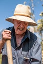 Senior man hand plowing in the field