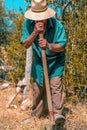 Senior man hand plowing in the field