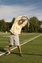 Senior man stretching exercising sports field Royalty Free Stock Photo