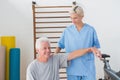 Senior man stretching with his therapist Royalty Free Stock Photo