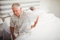 Senior man suffering from backache sitting on bed Royalty Free Stock Photo