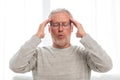 Senior man suffering from headache at home Royalty Free Stock Photo