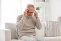 Senior man suffering from headache at home Royalty Free Stock Photo