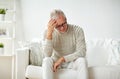 Senior man suffering from headache at home Royalty Free Stock Photo