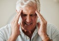 Senior man, suffering with headache pain from stress and painful head migraine. Elderly people at risk for mental health Royalty Free Stock Photo