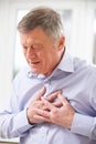 Senior Man Suffering Heart Attack At Home Royalty Free Stock Photo