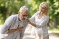 Senior man suffering from heart attack while walking with wife in park Royalty Free Stock Photo