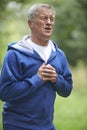 Senior Man Suffering Heart Attack Whilst Jogging Royalty Free Stock Photo