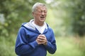 Senior Man Suffering Heart Attack Whilst Jogging Royalty Free Stock Photo