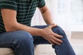 Senior man suffering from knee pain at home Royalty Free Stock Photo