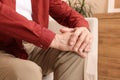 Senior man suffering from pain in his knee at home, closeup. Arthritis symptoms Royalty Free Stock Photo