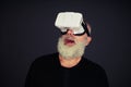Senior man surprised wearing hi-tech VR headset Royalty Free Stock Photo