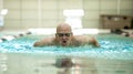 Senior man swimming competitively