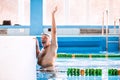 Senior man swimming in an indoor swimming pool. Royalty Free Stock Photo