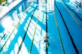 Senior man swimming in an indoor swimming pool. Royalty Free Stock Photo