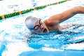 Senior man swimming in an indoor swimming pool. Royalty Free Stock Photo