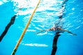 Senior man swimming in an indoor swimming pool. Royalty Free Stock Photo