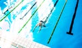 Senior man swimming in an indoor swimming pool. Royalty Free Stock Photo