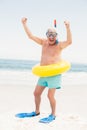 Senior man with swimming ring and flippers at the beach Royalty Free Stock Photo