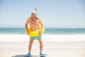 Senior man with swimming ring and flippers at the beach Royalty Free Stock Photo