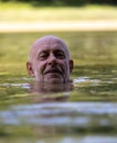 Senior man swimming in river Royalty Free Stock Photo