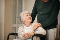 Senior man takes care of his old wife in a wheelchair