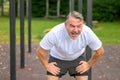 Senior man taking a break after working out outdoors in a park Royalty Free Stock Photo