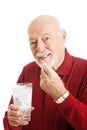 Senior Man Taking Fish Oil Capsule Royalty Free Stock Photo