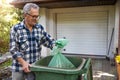 Senior man taking out garbage Royalty Free Stock Photo