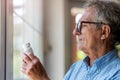 Senior man checking label on medication Royalty Free Stock Photo