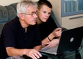 Senior man and teenager on laptop Royalty Free Stock Photo