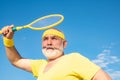 Senior man tennis player serving. Freedom retirement concept. Senior male is enjoying sporty lifestyle. Royalty Free Stock Photo