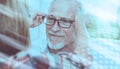 Senior man testing new eyeglasses; light effect Royalty Free Stock Photo
