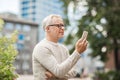 Senior man texting message on smartphone in city Royalty Free Stock Photo