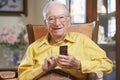 Senior man texting on mobile phone Royalty Free Stock Photo