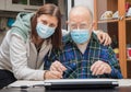 Senior Man with their Caregiver at Home during Coronavirus Pandemia Royalty Free Stock Photo