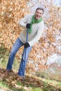 Senior man tidying leaves in garden Royalty Free Stock Photo