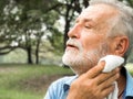 Senior man tired Wiping sweat with a towel in the park, health care concept Royalty Free Stock Photo