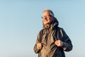 Senior man trail hiking in a mountain forest