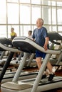 Senior man training his legs at gym.