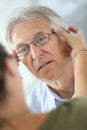 Senior man trying on new eyeglasses