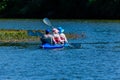 Senior man and two women kayaking on a Dnieper river