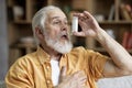 Senior man using asthma inhaler for allergies Royalty Free Stock Photo