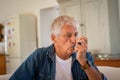 Senior man using asthma pump Royalty Free Stock Photo