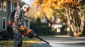 Senior Man Using Backpack Leaf Blower for Autumn Yard Work Royalty Free Stock Photo