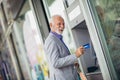 Old man using bank cash machine Royalty Free Stock Photo