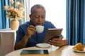 Senior man using digital tablet at table in nursing home Royalty Free Stock Photo